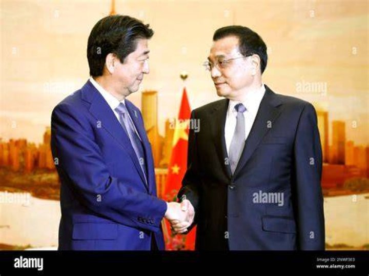 Abe shakes hands with China's President Xi Jinping in Beijing on November 10, 2014